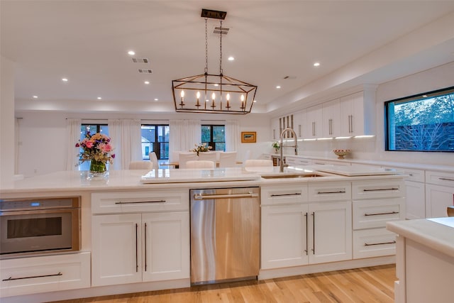 kitchen with white cabinetry, sink, and appliances with stainless steel finishes