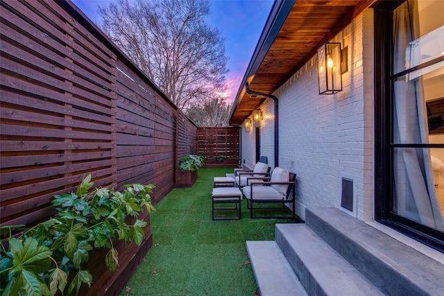 yard at dusk with an outdoor hangout area