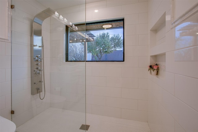 bathroom with a tile shower