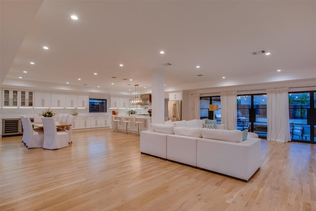 living room with wine cooler and light wood-type flooring