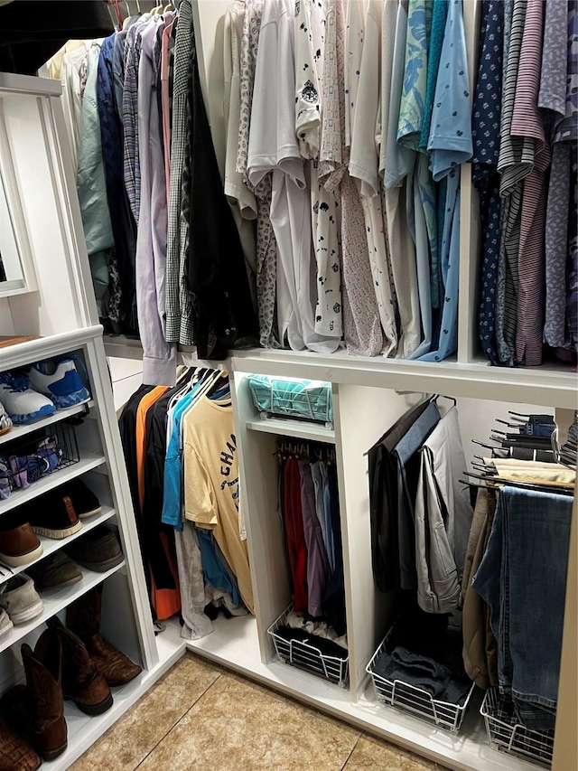 walk in closet with tile patterned floors