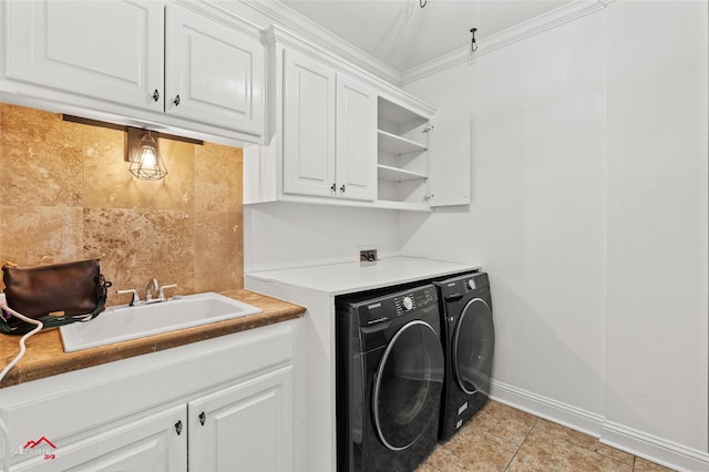 clothes washing area featuring cabinets, separate washer and dryer, sink, and light tile patterned floors