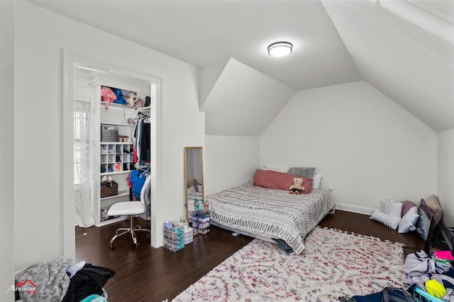 bedroom featuring lofted ceiling and dark hardwood / wood-style floors