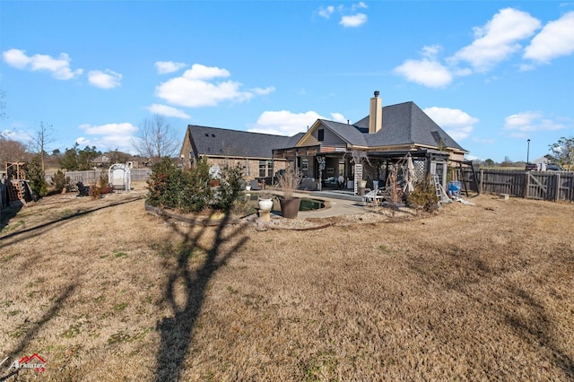 back of property featuring a lawn and a patio