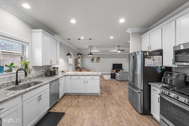 kitchen with white cabinetry, appliances with stainless steel finishes, pendant lighting, and kitchen peninsula