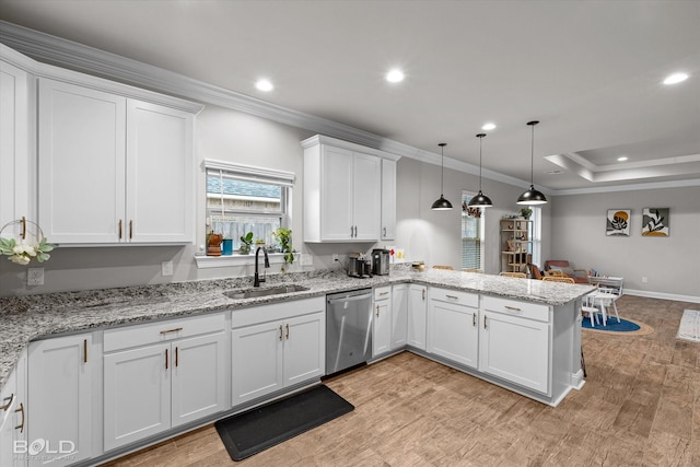 kitchen featuring sink, white cabinetry, decorative light fixtures, stainless steel dishwasher, and kitchen peninsula