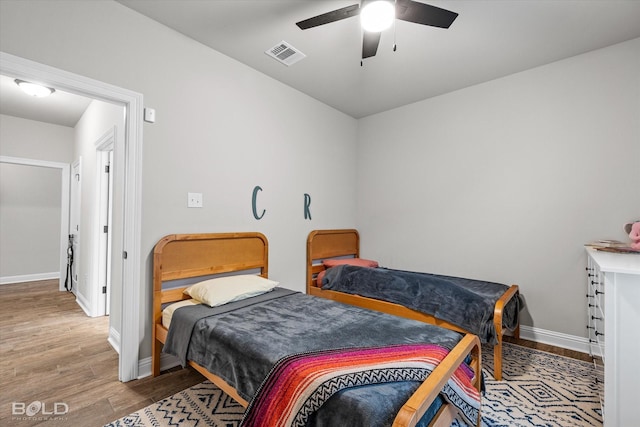 bedroom featuring wood-type flooring and ceiling fan