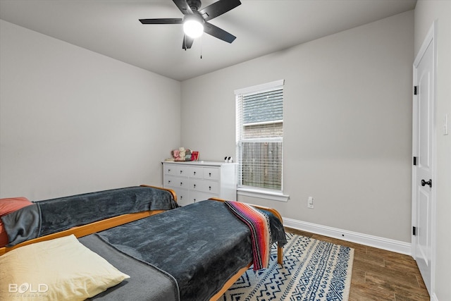 bedroom featuring dark hardwood / wood-style flooring and ceiling fan