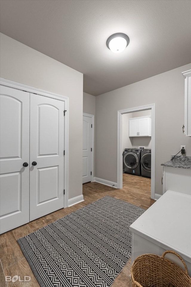 interior space featuring wood-type flooring and washing machine and clothes dryer