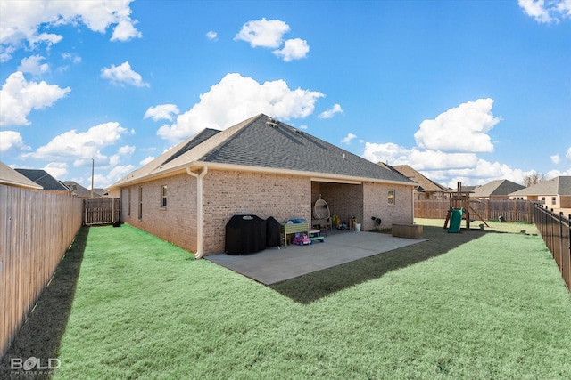 back of property with a lawn, a patio, and a playground