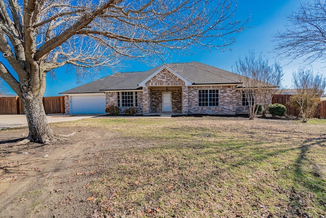 ranch-style home featuring a garage and a front yard