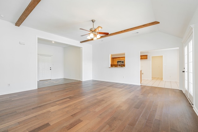 unfurnished living room featuring hardwood / wood-style flooring, ceiling fan, and lofted ceiling with beams