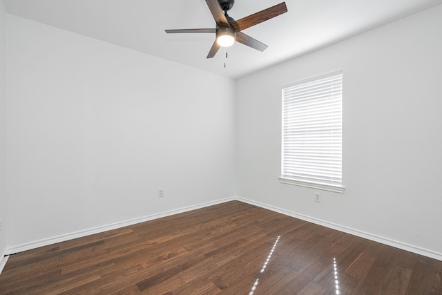 spare room with dark wood-type flooring and ceiling fan