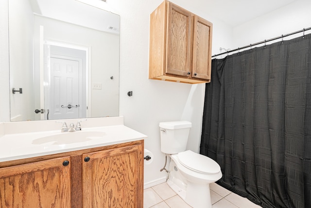 bathroom featuring vanity, toilet, and tile patterned flooring