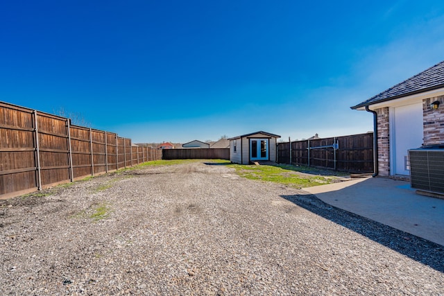 view of yard with a patio area, central AC unit, and a storage unit