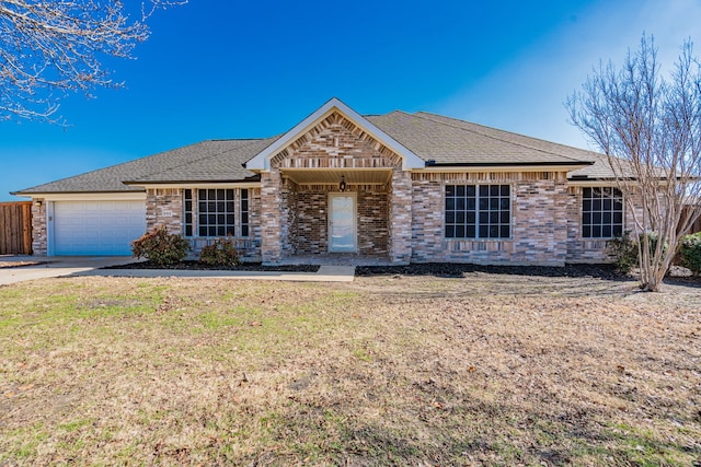 single story home featuring a garage and a front yard