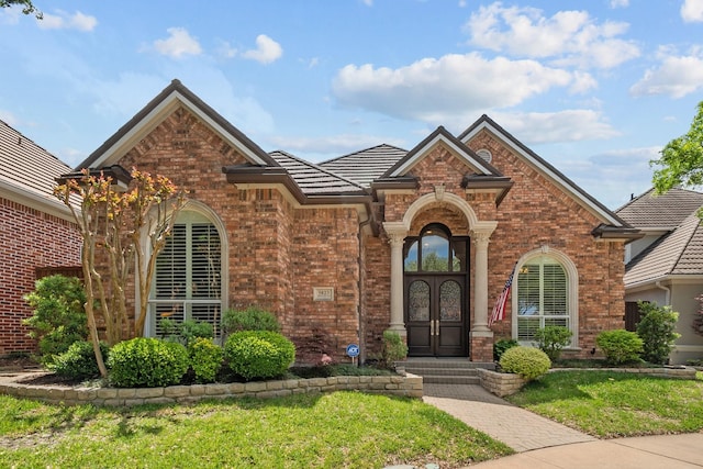 view of front facade featuring french doors and a front yard