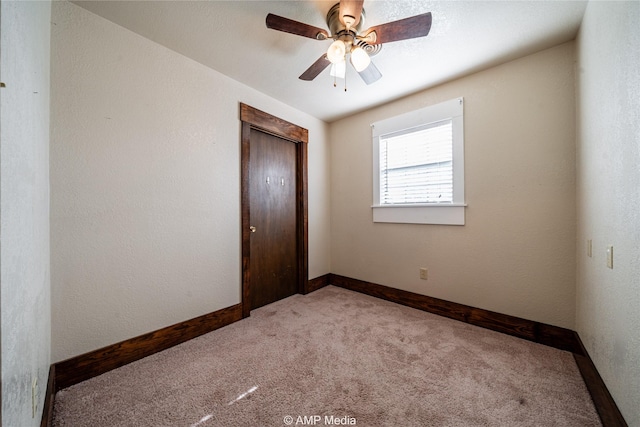 unfurnished bedroom with light colored carpet, a closet, and ceiling fan