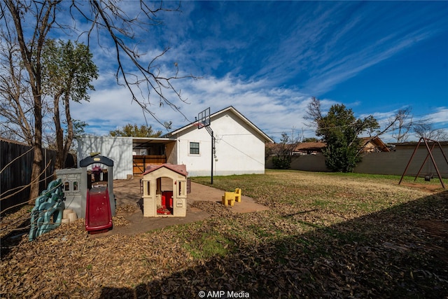 back of property featuring a lawn