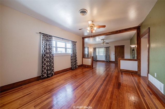 unfurnished living room with ceiling fan and hardwood / wood-style floors