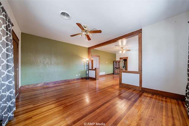 empty room with hardwood / wood-style flooring and ceiling fan