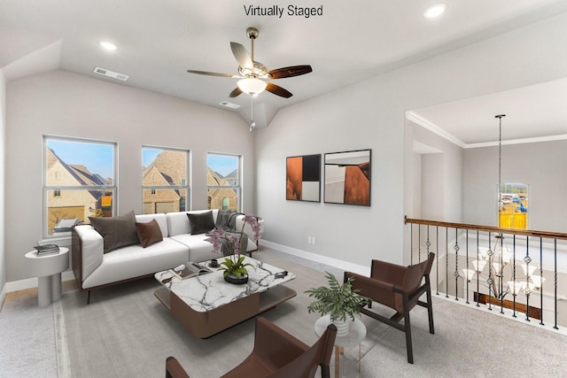 living room with vaulted ceiling, ceiling fan, crown molding, and carpet floors