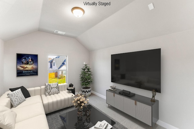 living room featuring lofted ceiling and carpet flooring