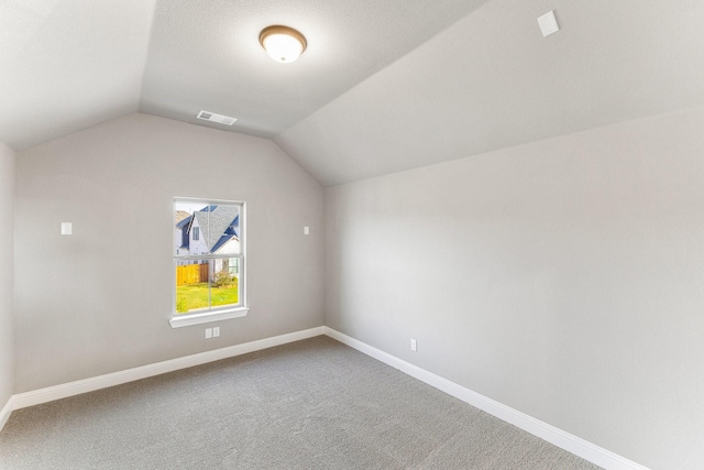 bonus room featuring lofted ceiling and carpet flooring