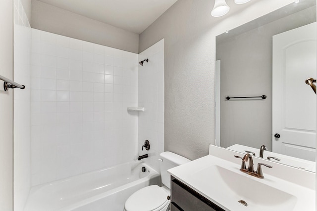 full bathroom featuring vanity, tiled shower / bath combo, and toilet