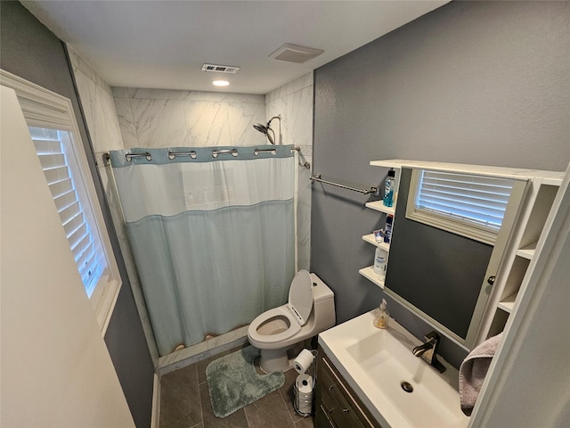 bathroom featuring vanity, toilet, curtained shower, and tile patterned flooring