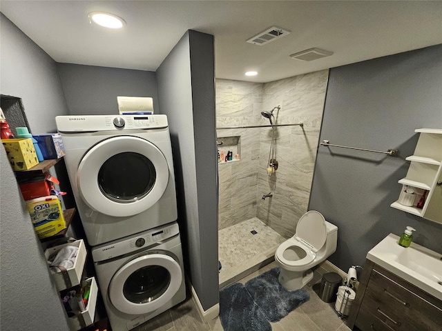 clothes washing area featuring stacked washer / drying machine and sink