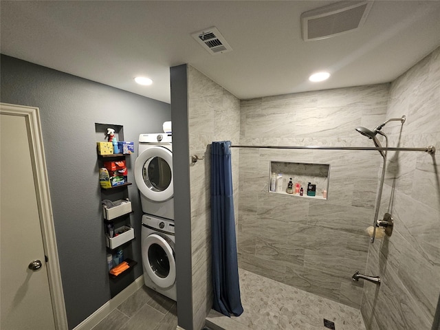 clothes washing area featuring stacked washer and dryer