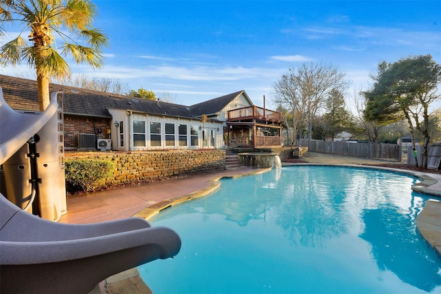 view of pool with central AC unit and a water slide