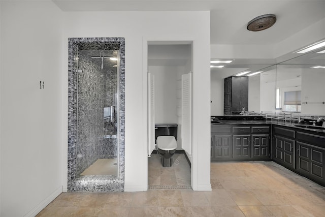 bathroom featuring tile patterned flooring, vanity, and walk in shower