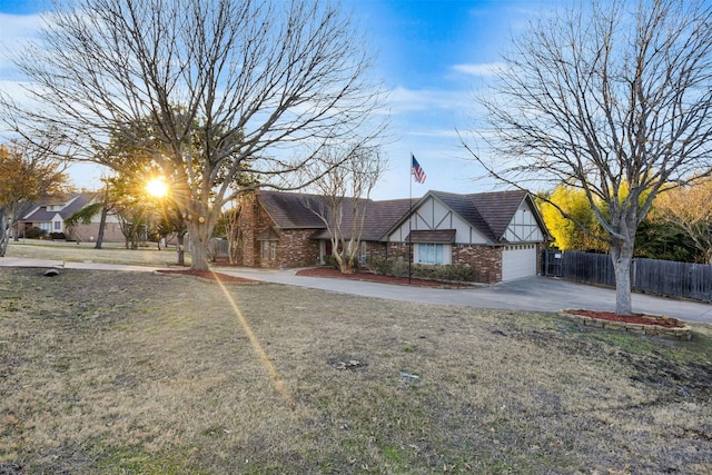 view of front of house with a garage and a front lawn