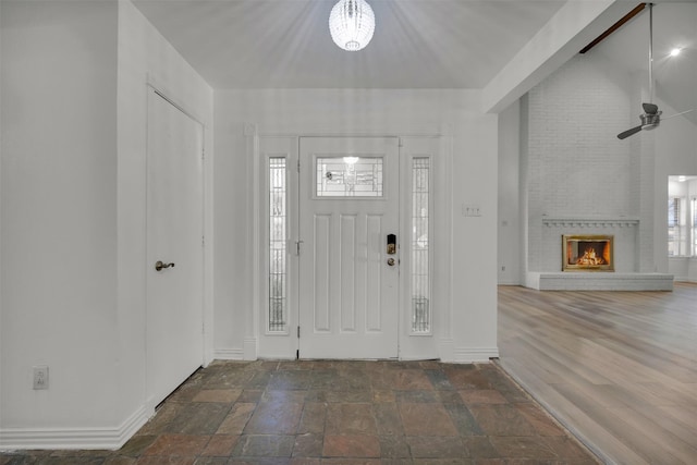 entrance foyer with dark hardwood / wood-style floors and a fireplace