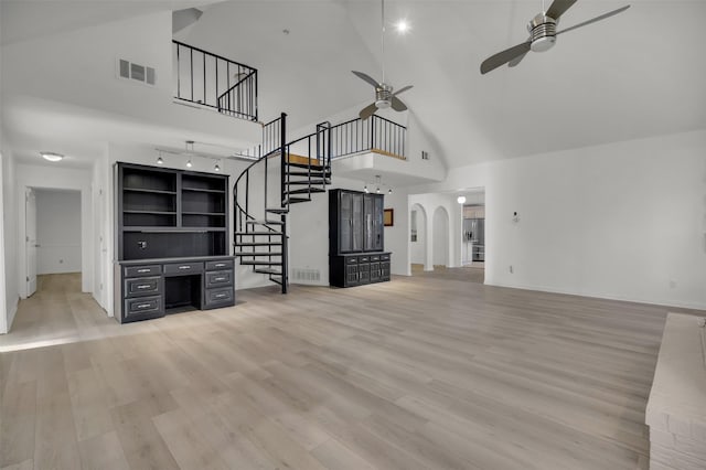 unfurnished living room featuring ceiling fan, high vaulted ceiling, and light hardwood / wood-style floors