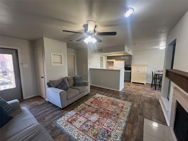 living room featuring dark hardwood / wood-style flooring and ceiling fan