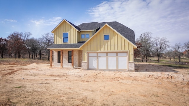 view of front of property with a porch and a garage