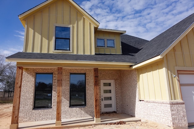 view of exterior entry with a porch