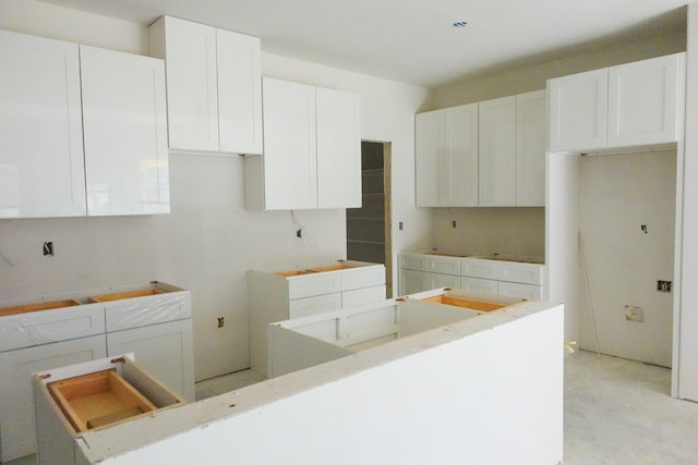 kitchen with a kitchen island and white cabinets