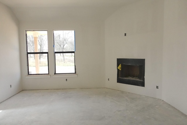 unfurnished living room featuring concrete floors