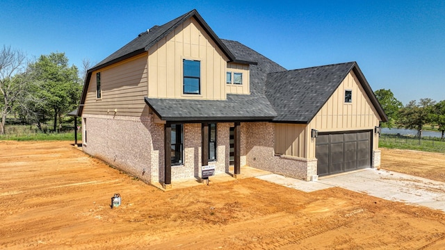 241 Zebrastone Way, Poolville, TX 76487 - modern farmhouse with brick siding, board and batten siding, driveway, a garage, and a shingled roof