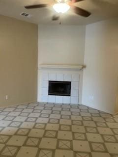 unfurnished living room with a fireplace and ceiling fan