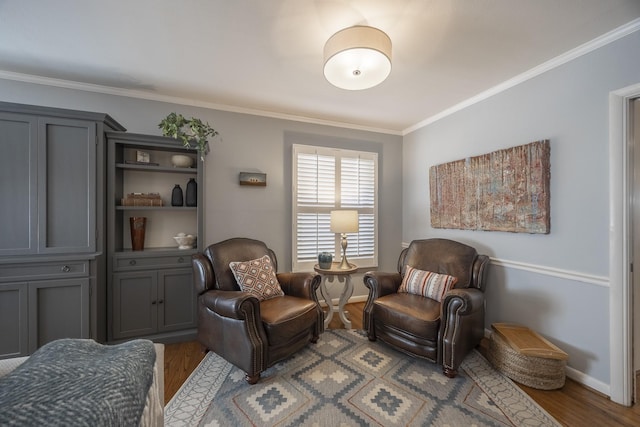 living area featuring crown molding and light hardwood / wood-style flooring