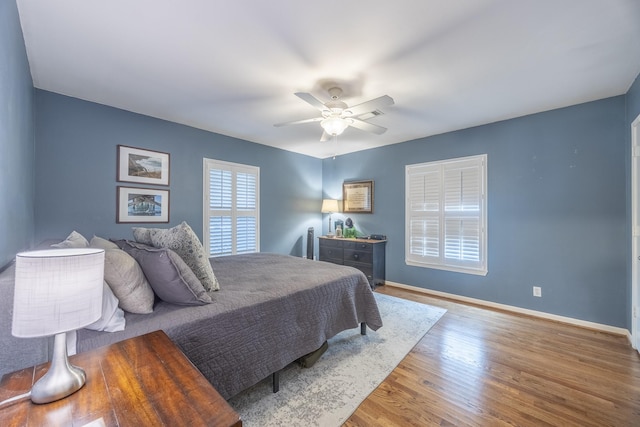 bedroom with hardwood / wood-style flooring and ceiling fan