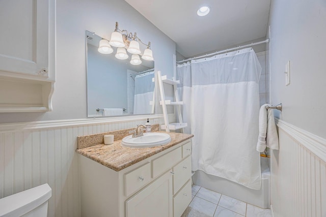 bathroom with vanity, tile patterned floors, and shower / bath combo with shower curtain