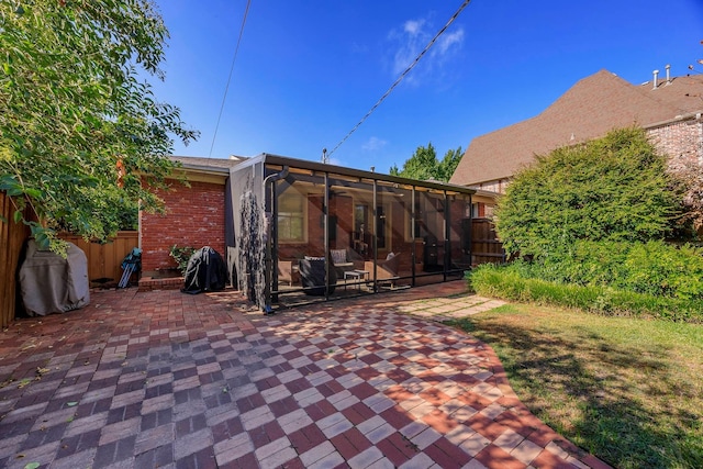 rear view of house with a patio and a sunroom