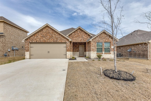 view of front of property featuring cooling unit and a garage