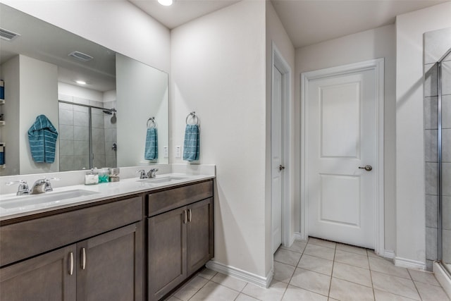 bathroom featuring tile patterned flooring, vanity, and a shower with shower door